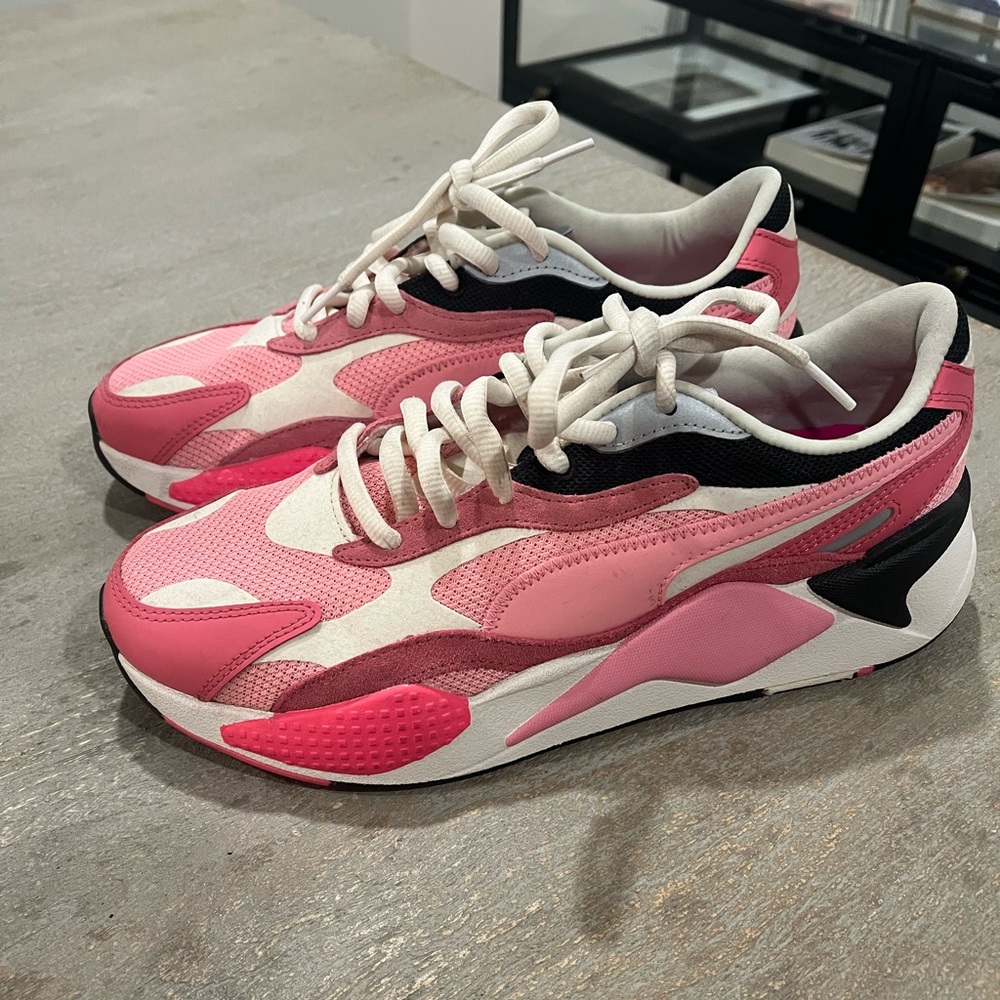 Women’s pink puma sneakers in a size 11.